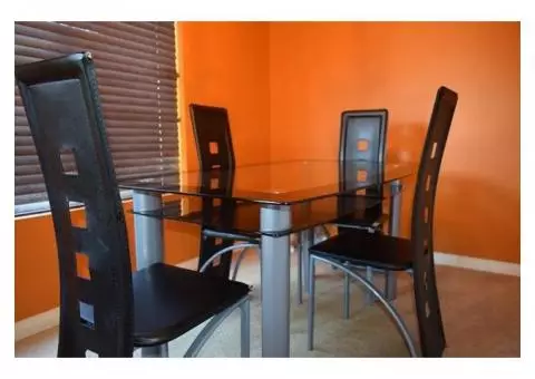 Contemporary style dining table with four chairs